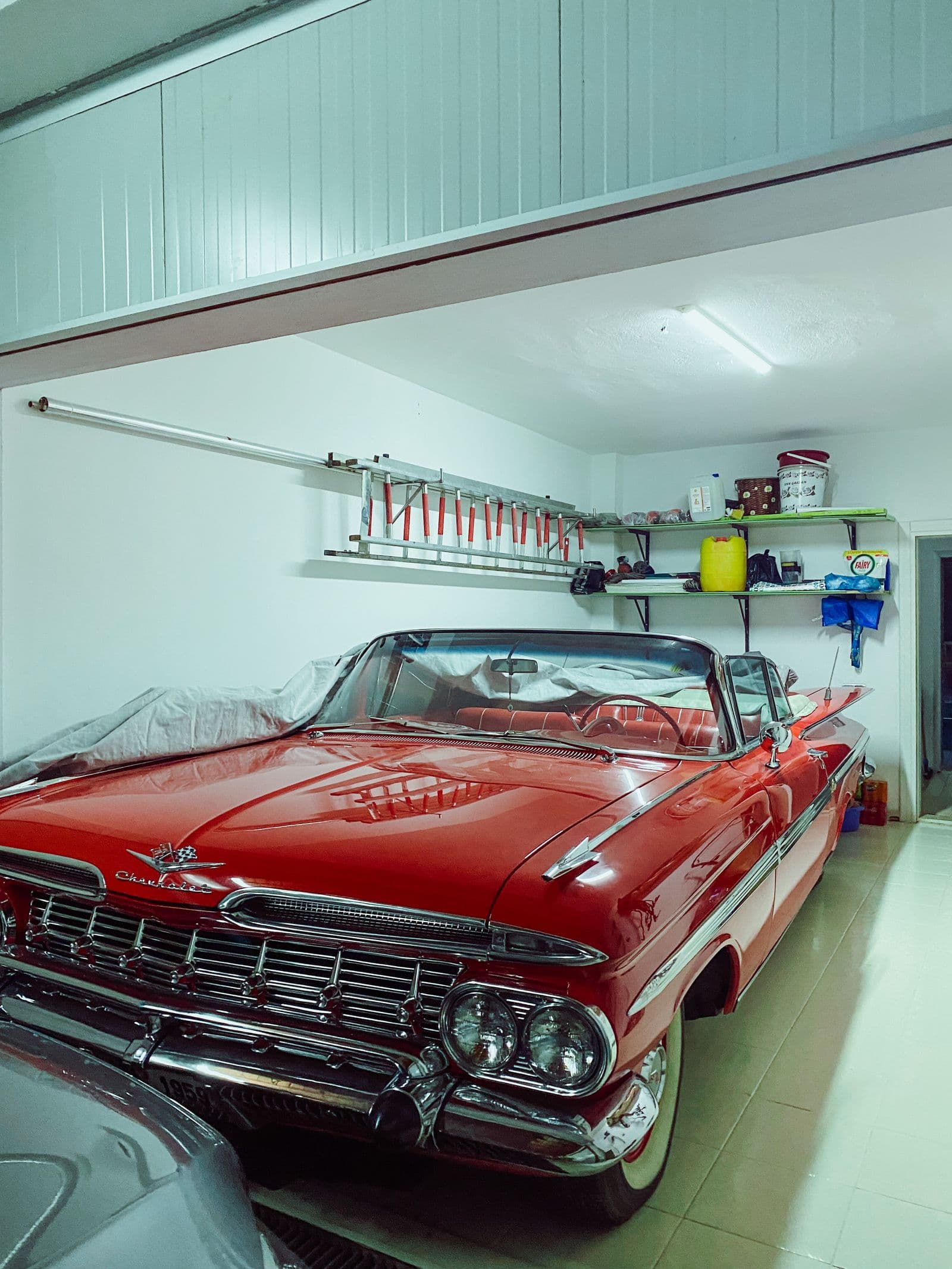 Residential garage with a light coated floor and organized storage